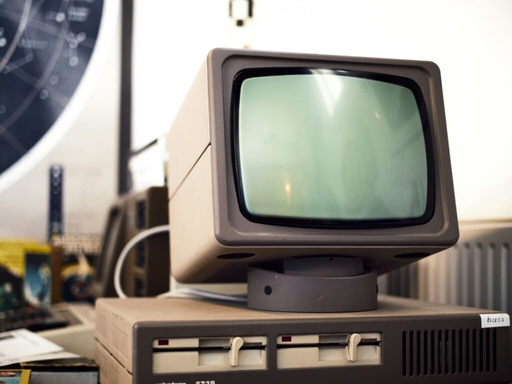Monitor de computador vintage com drives de disquete externos, remetendo à era do Amiga